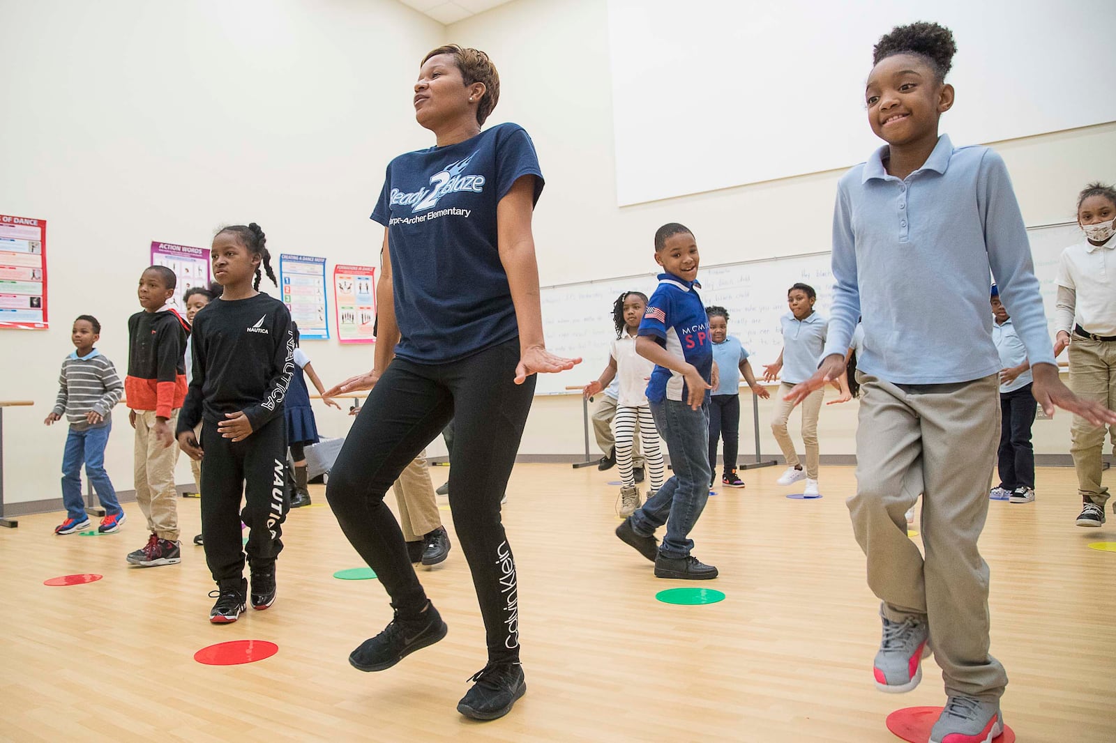 Harper-Archer Elementary School third graders mimic dance teacher Lisa Perrymond (center) as they learn more steps to an African themed dance they are learning during class inside the school's dance studio, Tuesday, January 28, 2020. (ALYSSA POINTER/ALYSSA.POINTER@AJC.COM)