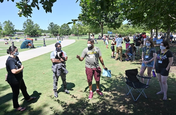 July 11, 2020 Suwanee - Demetrius Nelson (center), 7th grade math teacher at Summerour middle school leads a small group discussion during Gwinnett Citizens for Equity and Justice event, a rally and information session organized by Gwinnett Educators for Equity & Justice, at Town Center Park in Suwanee on Saturday, July 11, 2020. They are explaining their stance on forcing Gwinnett schools to include implicit bias training for educators, include cultural and racial history and education in curriculum and hire more teachers of color.  (Hyosub Shin / Hyosub.Shin@ajc.com)