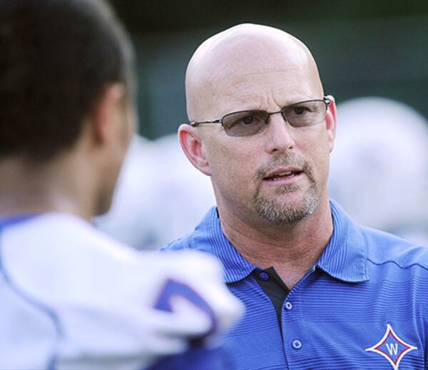 Walton coach Maurice Dixon praised his four seniors for taking care of their academics while still remaining “legit and brutal,” football players. (John Amis/Special to AJC)