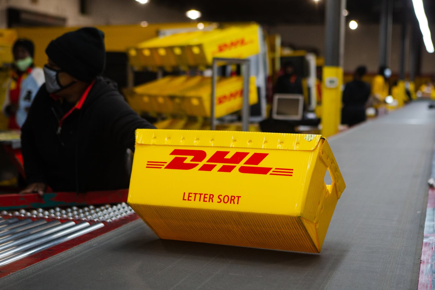 A DHL box is sent down the conveyer belt on Wednesday, December 16, 2020, at DHL Express in Atlanta. Workers at the shipping center worked to fulfill orders during the holiday rush. CHRISTINA MATACOTTA FOR THE ATLANTA JOURNAL-CONSTITUTION.