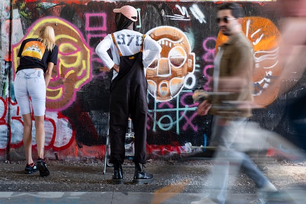 Malcolm Turpin watches Jade Thomasson as he teaches a graffiti class. Turpin has been spray-painting for about a decade.