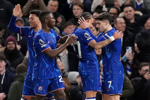 Chelsea's Pedro Neto, right, celebrates with teammates after scoring their side's second goal of the game during the English Premier League soccer match between Chelsea and Southampton at Stamford Bridge, London, Tuesday, Feb. 25, 2025. (John Walton/PA via AP)