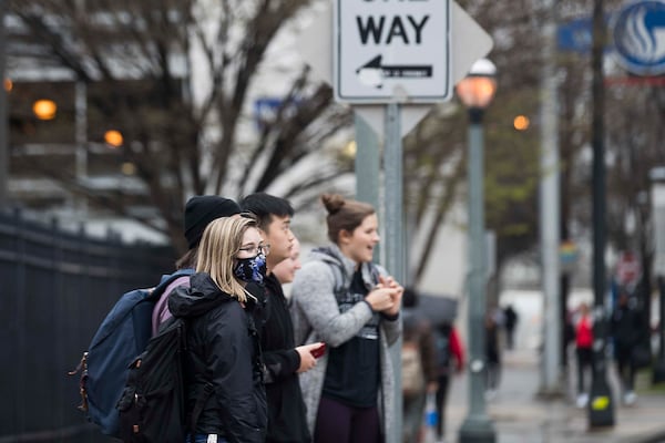 Georgia State University undergrad sophomore Emma Berman wears a face mask while navigating the university's campus in Atlanta, Tuesday, March 10, 2020. Bearman, a Cobb County resident who has asthma, says she wears the mask for herself but also because her mother has an auto immune disorder. She ordered the mask a few weeks ago and has been wearing it to classes. Bearman works in retail  but has opted out of wearing the mask to work. She says her job is allowing workers to wear gloves. 