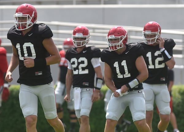 Georgia quarterbacks Jacob Eason (10), Stetson Bennett (22), Jake Fromm (11), and Brice Ramsey run between drills during the annual UGA Fan Day at Sanford Stadium on Saturday, Aug 5, 2017 in Athens, Ga. 
(RICHARD HAMM)