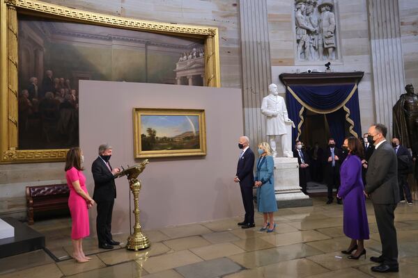 Sen. Roy Blunt, R-Mo, presents a painting to President Joe Biden and first lady Jill Biden, as Vice President Kamala Harris and second gentleman Doug Emhoff look on at the presentation of gifts ceremony after the 59th Presidential Inauguration at the U.S. Capitol in Washington, Jan. 20. Win McNamee/Getty Images/Pool Photo via AP