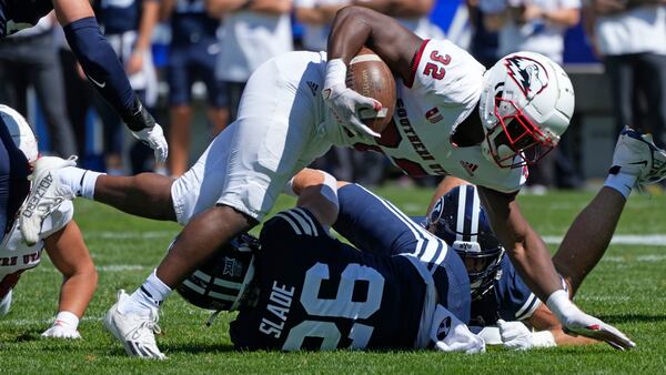 FILE - Southern Utah running back Targhee Lambson (32) is tackled by BYU safety Ethan Slade (26) during the first half of an NCAA college football game Saturday, Sept. 9, 2023, in Provo, Utah. (AP Photo/Rick Bowmer, File)