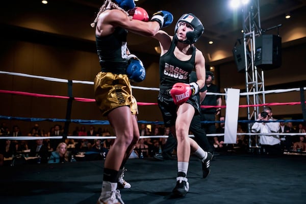 Erica Rodriguez (right) participated in the boxing charity event Brawl for a Cause in April. She hoped that purse money could pay for her daughter’s medical expenses. Although she lost the fight, she continues to box. CONTRIBUTED BY RANDMC PHOTOGRAPHY