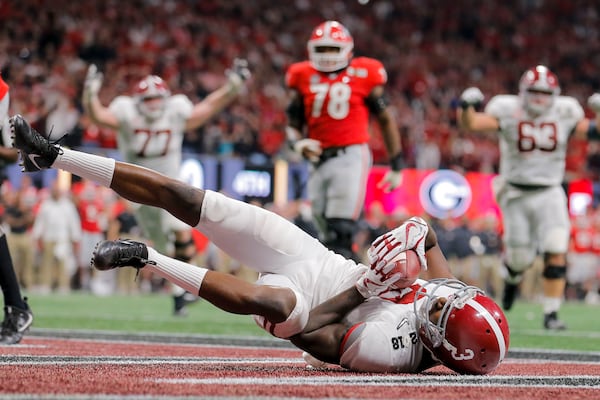 01/08/2018 -- Atlanta, GA - Alabama Crimson Tide wide receiver Calvin Ridley (3) lands on his back after successfully catching a touchdown pass during the fourth quarter of the College Football Playoff National Championship at Mercedes-Benz stadium in Atlanta, Monday, January 8, 2018. The Georgia Bulldogs lost to the Alabama Crimson Tide in OT, 23-26. ALYSSA POINTER/ALYSSA.POINTER@AJC.COM