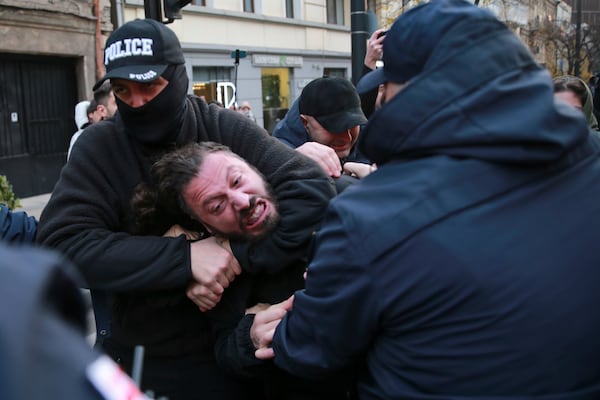 Police try to detain a protester in a street during a rally against the results of the parliamentary elections amid allegations that the vote was rigged in Tbilisi, Georgia, early Monday, Nov. 18, 2024. (AP Photo/Zurab Tsertsvadze)