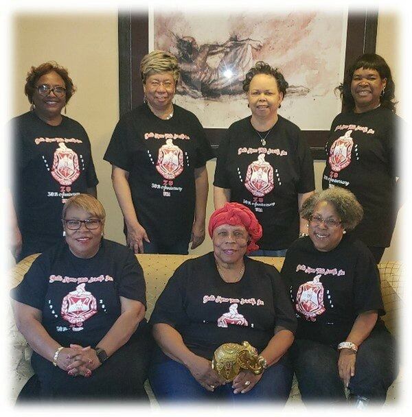 Members of the University of Georgia’s chartering Delta Sigma Theta line, with their advisor from 1969, Jontyle Robinson (crimson headscarf in the middle). The women who chartered the chapter, known as “The Great Eight,” include (top row, L-R): Beverly Johnson Hood, Carrie Gantt, Deborah Bailey Poole and Barbara Atkinson Moss. (Bottom row), left, Helen Butler and right, Cheryl Jordan. A seventh sister, Bendel Love Rucker, is not pictured. The eight sister,  Carolyn Baylor Reed, is deceased. Courtesy Zeta Psi Chapter of Delta Sigma Theta. 