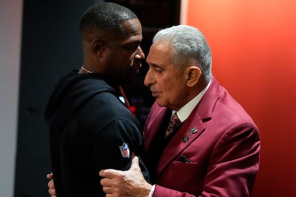 Falcons owner Arthur Blank speaks with head coach Raheem Morris after Sunday's season-ending loss.