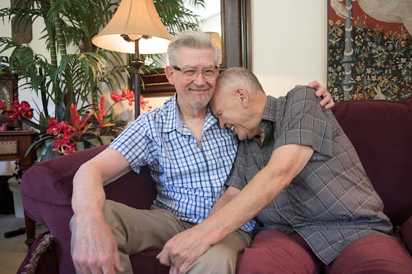 Charles Dillard, aka Mr. Charlie Brown, right, and his husband Fred Wise laugh while sitting for a photo at their residence in Austell, Georgia in 2019. (Alyssa Pointer/The Atlanta Journal-Constitution/TNS)