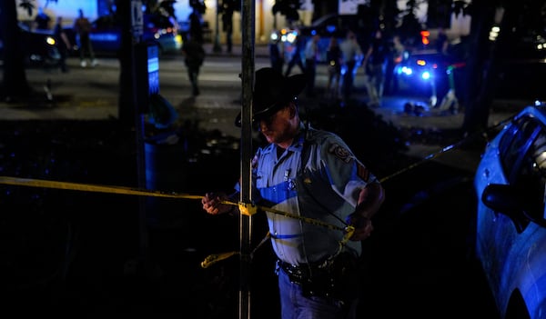 Officers rope off the crime scene after the shooting.