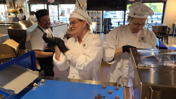 Workers at Bitzel’s Chocolate demonstrate how the treats are made at the Suwanee factory.