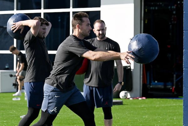 Braves first baseman Matt Olson (foreground) tosses a medicine ball alongside third baseman Austin Riley (left) on Wednesday in North Port, Florida.