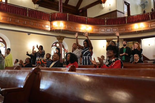 FILE - Mother Bethel AME Church congregants react to the sermon by senior pastor, Rev. Mark Tyler, in Philadelphia, Sept. 29, 2024. (AP Photo/Luis Andres Henao, File)