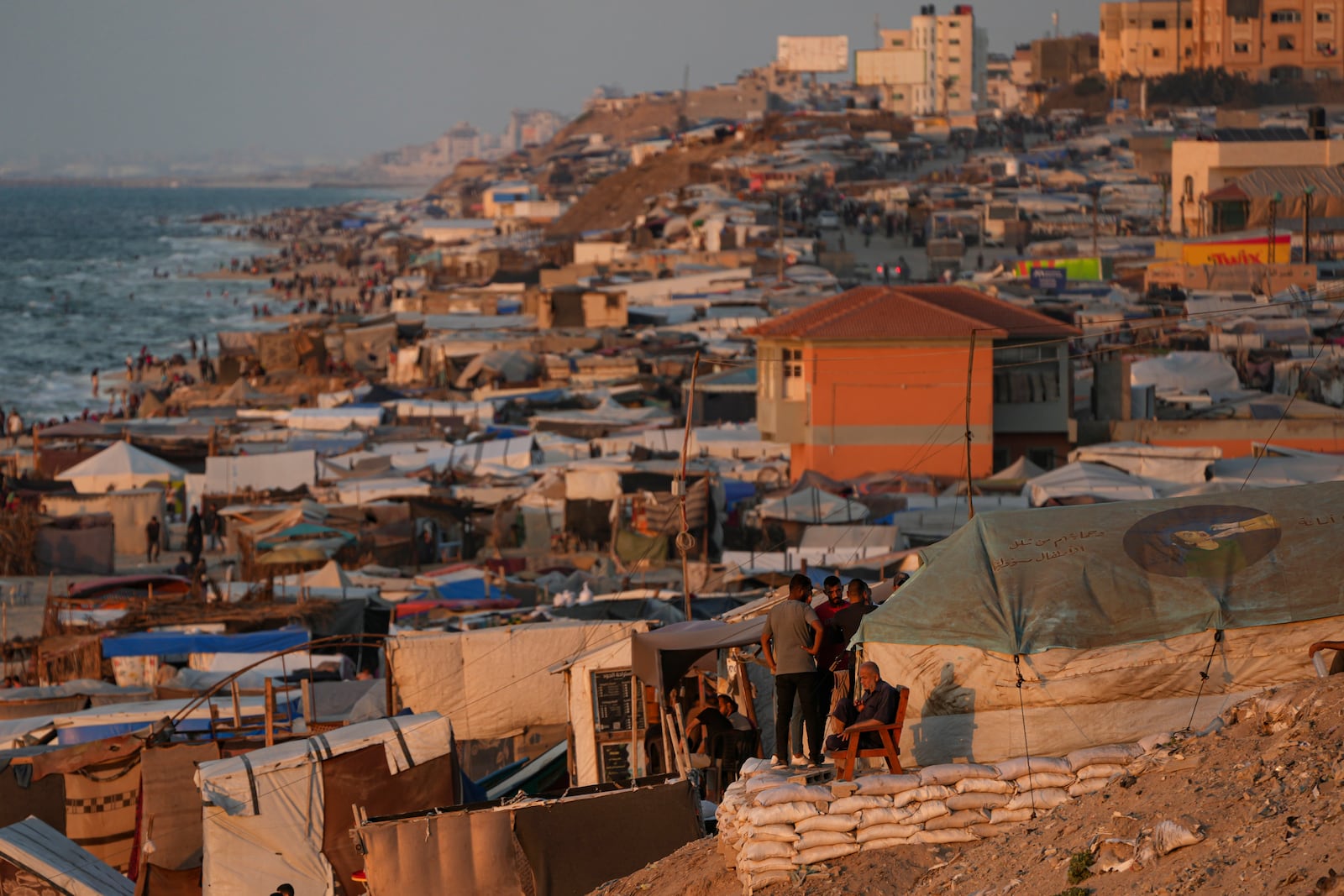 Tents are crammed together as displaced Palestinians camp along the beach of Deir Al Balah, central Gaza Strip, Wednesday, Oct. 9, 2024. (AP Photo/Abdel Kareem Hana)