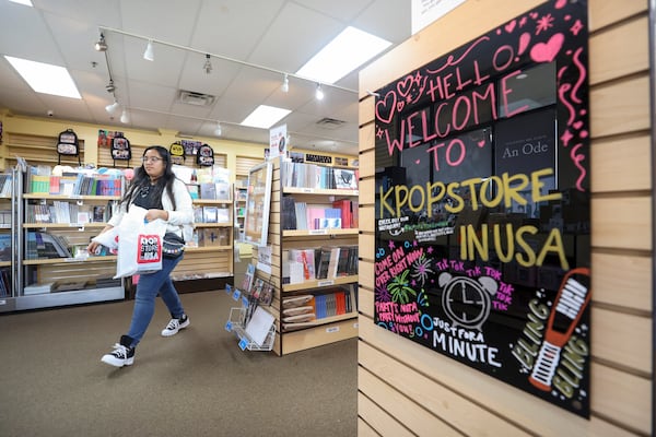 K-pop fan Cruz Segura of Hapeville leaves after shopping at the KPOP Store in USA in Doraville. (Jason Getz / Jason.Getz@ajc.com)