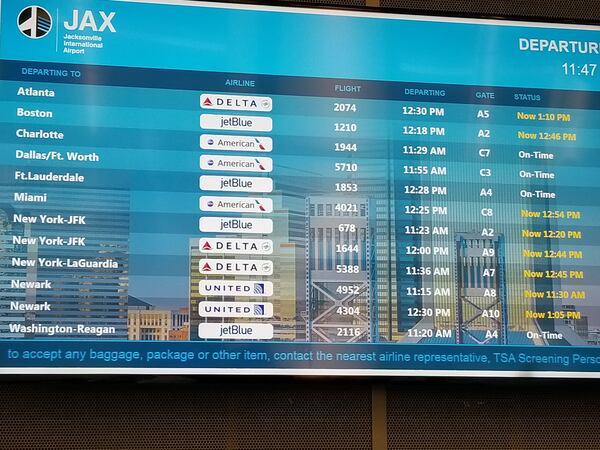 A flight information display shows delayed flights on January 25, 2019 at Jacksonville International Airport. The delays were caused by shortages of air traffic controllers at two major Federal Aviation Administration facilities.