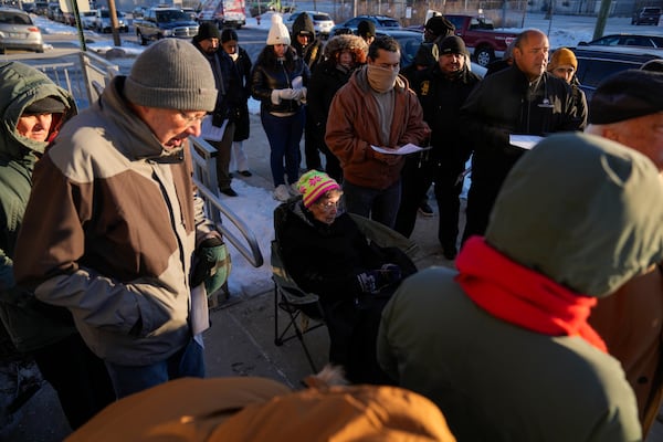 Sister JoAnn Persch, center, 90, a nun with the Sisters of Mercy, prays with others during a vigil outside a United States Customs and Immigration Enforcement detention facility Friday, Feb. 21, 2025, in Broadview, Ill. (AP Photo/Erin Hooley)