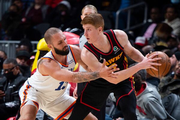 New York Knicks guard Evan Fournier (13) defends Atlanta Hawks guard Kevin Huerter (3) during the second half of an NBA basketball game Saturday, Nov. 27, 2021, in Atlanta. (AP Photo/Hakim Wright Sr.)