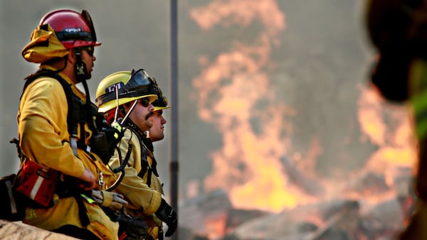 Firefighters battle a blaze at the Salvation Army Camp on November 10, 2018 in Malibu, California. Disney donated $500,000 to support firefighters in the state.