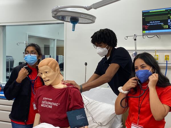 Gwinnett County students at the Opportunities Academy at Philadelphia College of Osteopathic Medicine in Suwanee listen to the mechanical lungs inside a mannequin during a simulated emergency room activity. (Josh Reyes / Josh.Reyes@ajc.com)