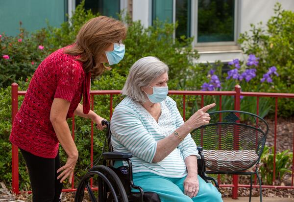 Sandi Thurber and resident Patricia Warner enjoy the garden at Northside Gwinnett Extended Care Center in Lawrenceville. (Phil Skinner for The Atlanta Journal-Constitution) 