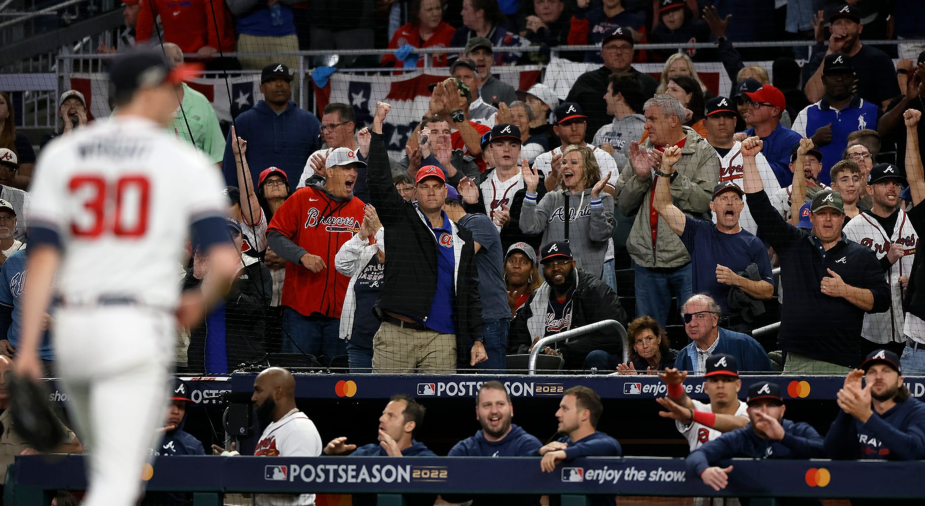 Atlanta Braves fans react after starting pitcher Kyle Wright (30) strikes out Philadelphia Phillies left fielder Kyle Schwarber (12) during the third inning of game two of the National League Division Series at Truist Park in Atlanta on Wednesday, October 12, 2022. (Jason Getz / Jason.Getz@ajc.com)