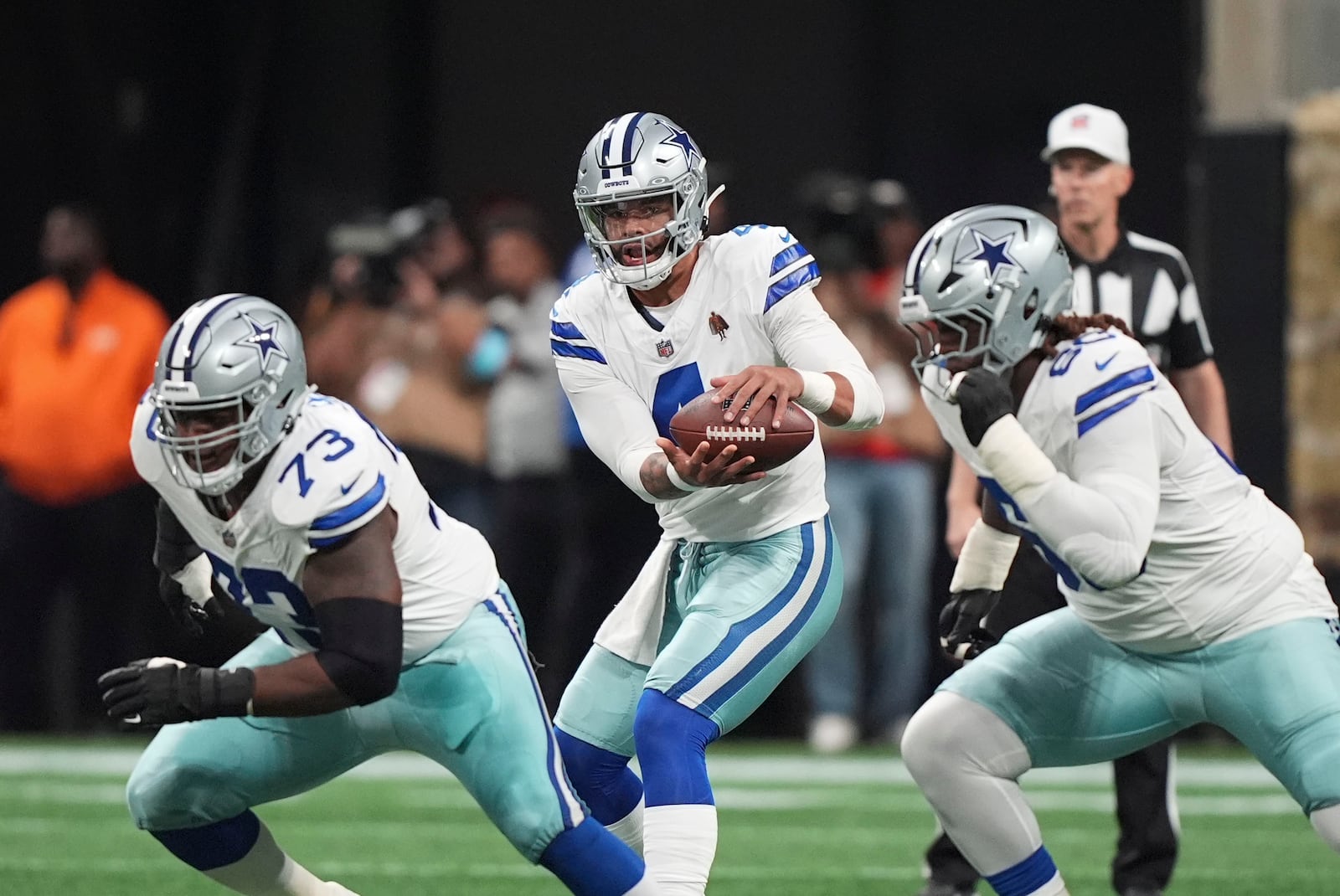 Dallas Cowboys quarterback Dak Prescott (4) takes a snap during the first half of an NFL football game against the Atlanta Falcons, Sunday, Nov. 3, 2024, in Atlanta. (AP Photo/ Brynn Anderson)