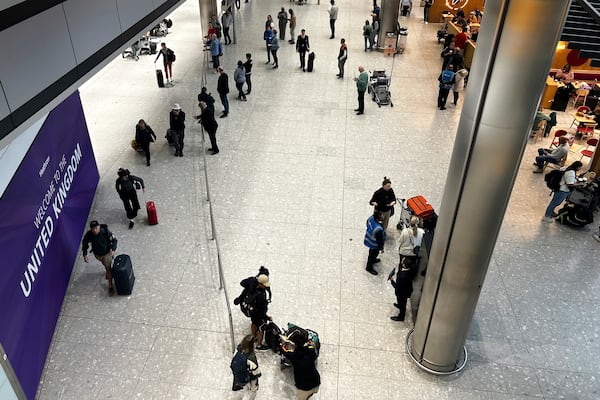 Travellers arrive at Terminal 5 as Heathrow Airport slowly resumes flights after a fire cut power to Europe's busiest airport in London, Saturday, March 22, 2025.(AP Photo/Kirsty Wigglesworth)