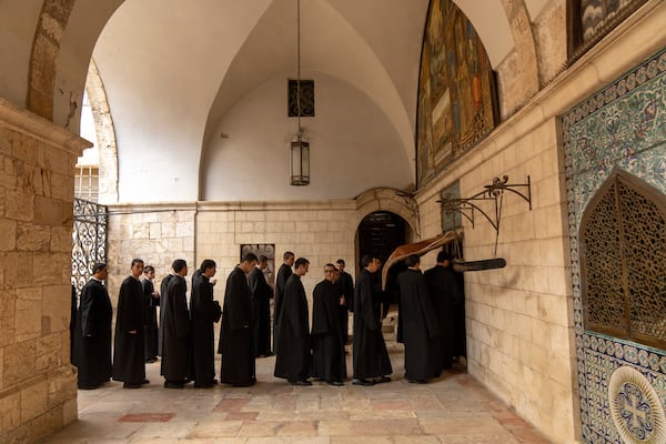 Young seminarians of the Armenian Christian convent arrive for the daily afternoon prayer service at St. James Cathedral at the Armenian quarter in Jerusalem, Thursday, Nov. 21, 2024. (AP Photo/Francisco Seco)