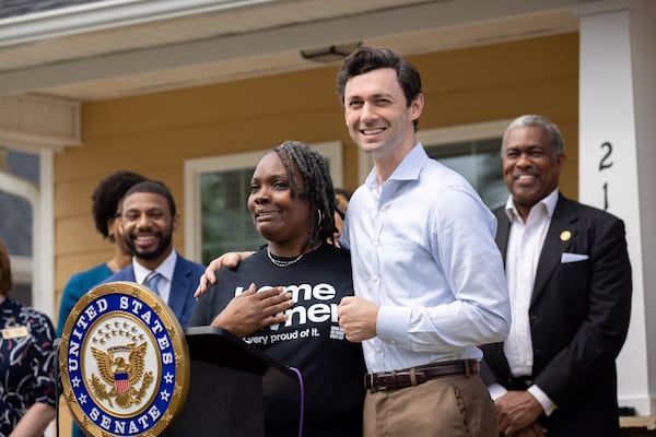 U.S. Sen. Jon Ossoff (right), D-Ga, stands with new homeowner Tanjills Sawyer at a press conference in Hampton on Monday, May 6, 2024 announcing federal funds for housing in Clayton County.(Arvin Temkar / AJC)