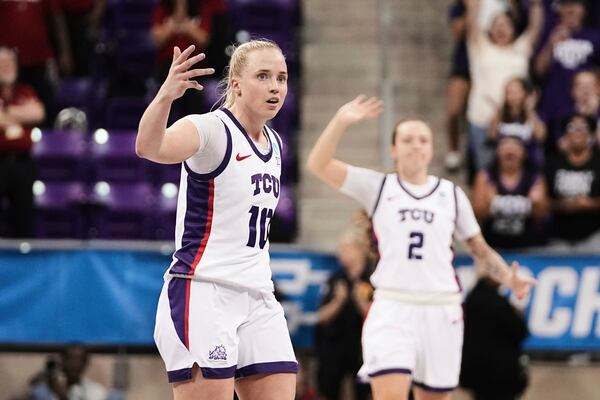 TCU's Hailey Van Lith (10) and Madison Conner (2) celebrate in the second half against Louisville in the second round of the NCAA college basketball tournament in Fort Worth, Texas, Sunday, March 23, 2025. (AP Photo/Tony Gutierrez)