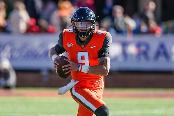 National Team quarterback Desmond Ridder, of Cincinnati, scrambles left during the first half of an NCAA Senior Bowl college football game, Saturday, Feb. 5, 2022, in Mobile, Ala. (AP Photo/Butch Dill)