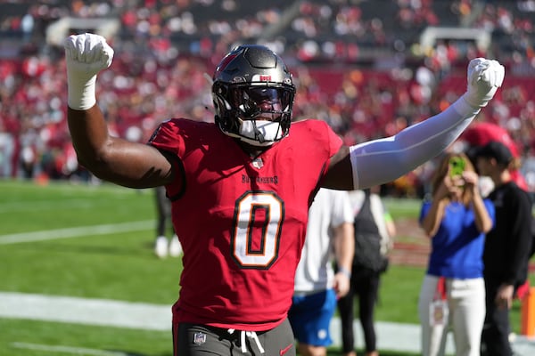 Tampa Bay Buccaneers linebacker Yaya Diaby (0) greets fans as he jogs into the locker room before an NFL football game against the New Orleans Saints, Sunday, Dec. 31, 2023, in Tampa, Fla. (AP Photo/Peter Joneleit)