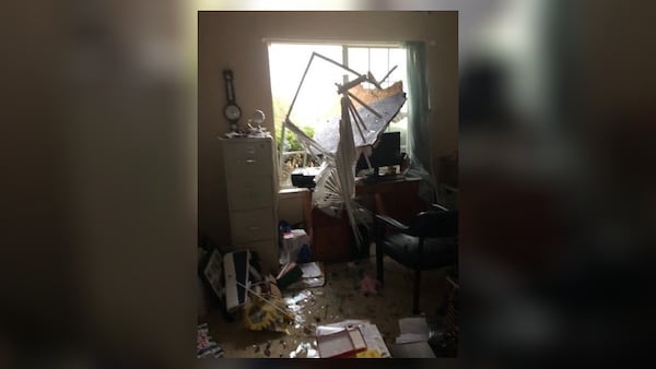 The tornado blew out windows and left behind debris and shattered glass.