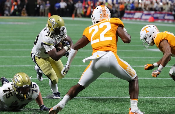 Jackets running back KirVonte Benson runs for yardage setting up a go ahead touchdown to take a 14-7 lead over Tennessee during the second quarter in a NCAA college football game on Monday, September 4, 2017, in Atlanta.    Curtis Compton/ccompton@ajc.com