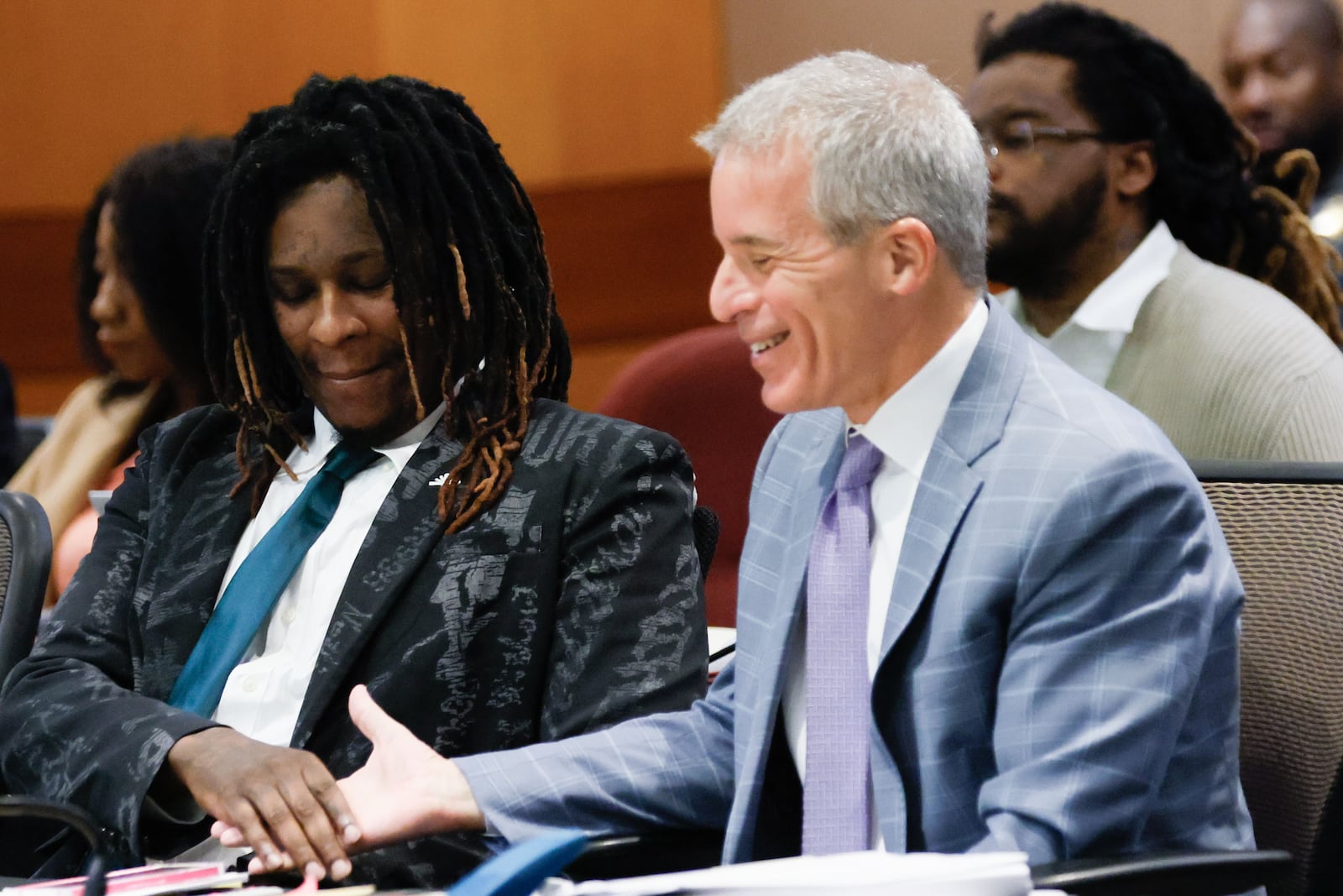 Atlanta rapper Young Thug (left, birth name Jeffery Williams) shakes hands with attorney Brian Steel during a July court hearing.