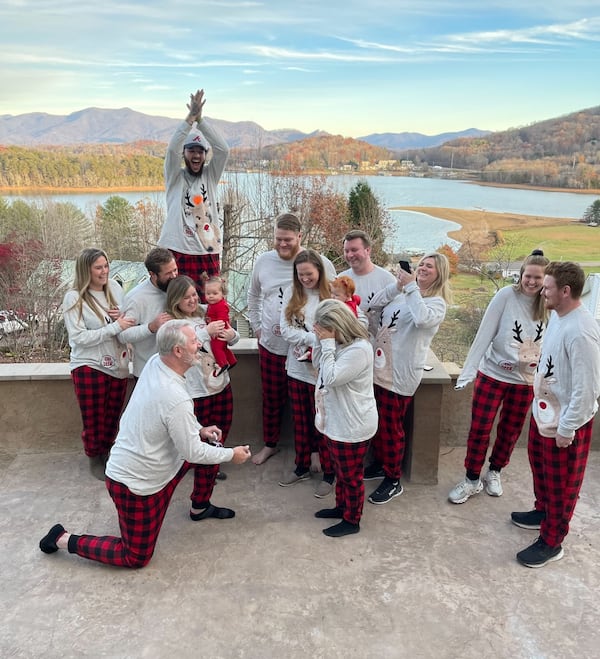 Rondie Raines Vaughn, front, is surprised by now-husband Trace Vaughn’s proposal during a family Christmas photo shoot at Trace’s house on Lake Chatuge.