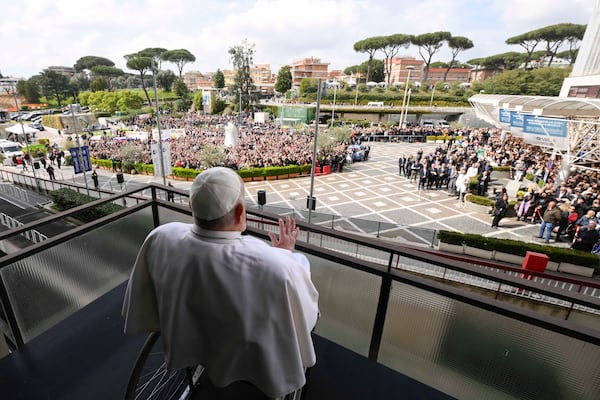 Pope Francis waves as he appears at a window of the Agostino Gemelli Polyclinic in Rome, Sunday, March 23, 2025, where he has been treated for bronchitis and bilateral pneumonia since Feb. 14. (Francesco Sforza/Vatican press office via AP)