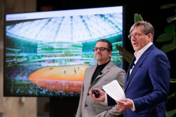 Jerry Alexander, left, and Kristopher Stuart, right, both principals with Gensler Architects, speak as they present artists renderings of proposed renovations for the now dormant Astrodome during a press conference held by the Astrodome Conservancy at The Ion, Wednesday, Nov. 13, 2024, in Houston. (AP Photo/Michael Wyke)