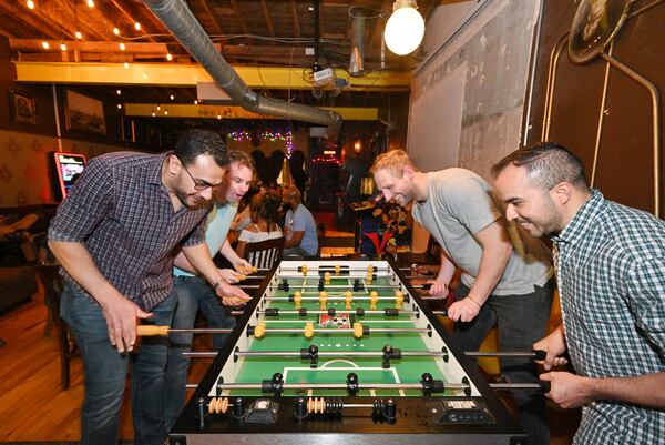 April 30, 2022 Atlanta - Guests play table football game at Joystick Gamebar on Edgewood Ave in Atlanta on Saturday, April 30, 2022. (Hyosub Shin / Hyosub.Shin@ajc.com)