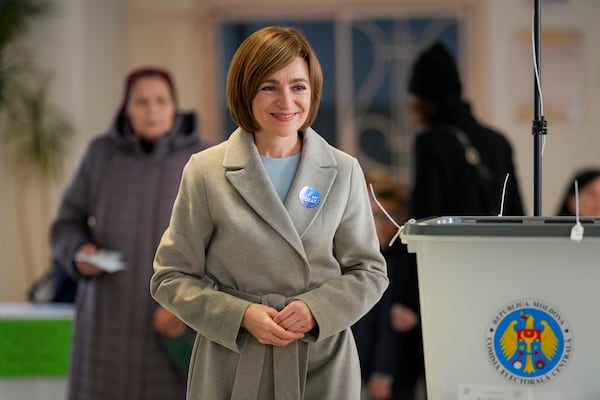 Moldova's President Maia Sandu smiles after casting her vote during a presidential election runoff, in Chisinau, Moldova, Sunday, Nov. 3, 2024. (AP Photo/Vadim Ghirda)