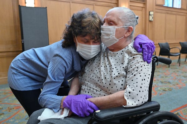 Lisa Hecht hugs her mother Fran Lefkoff, 86, as she visits her mother face-to-face after months of restrictions at The William Breman Jewish Home in Atlanta on Thursday. (Hyosub Shin / Hyosub.Shin@ajc.com)