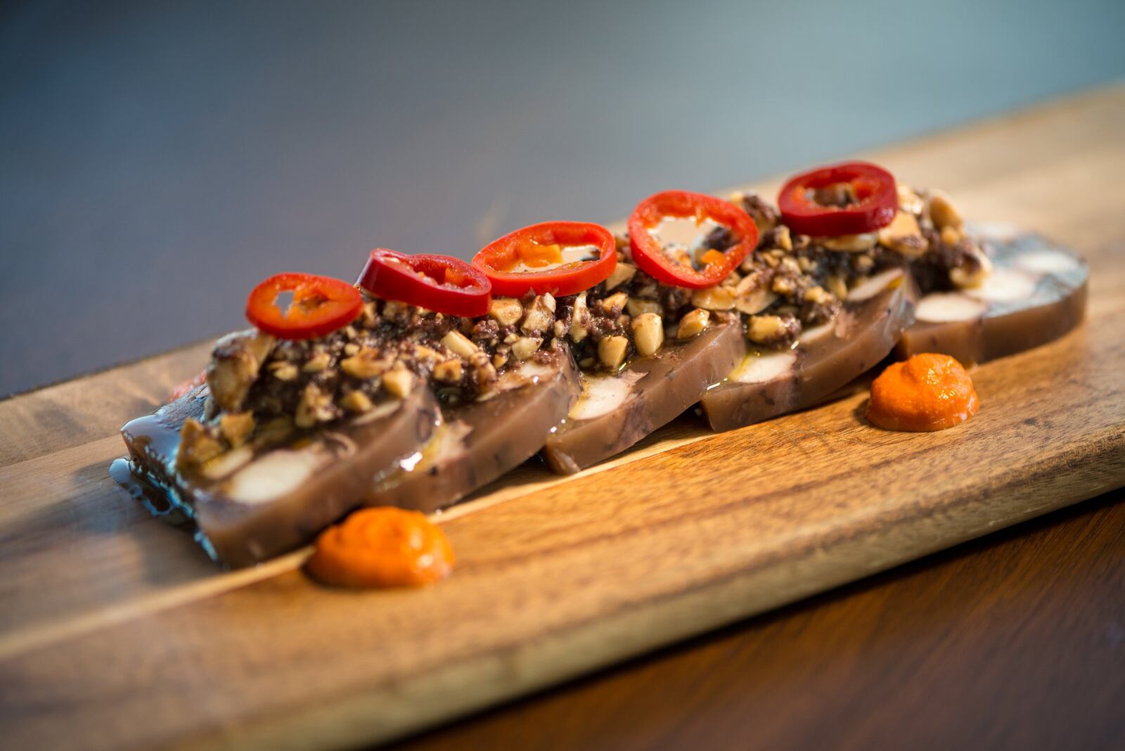 Apron Octopus Terrine with marcona almonds, lemon, boquerones, pickled fresnos, olives, and romesco. Photo credit- Mia Yakel.