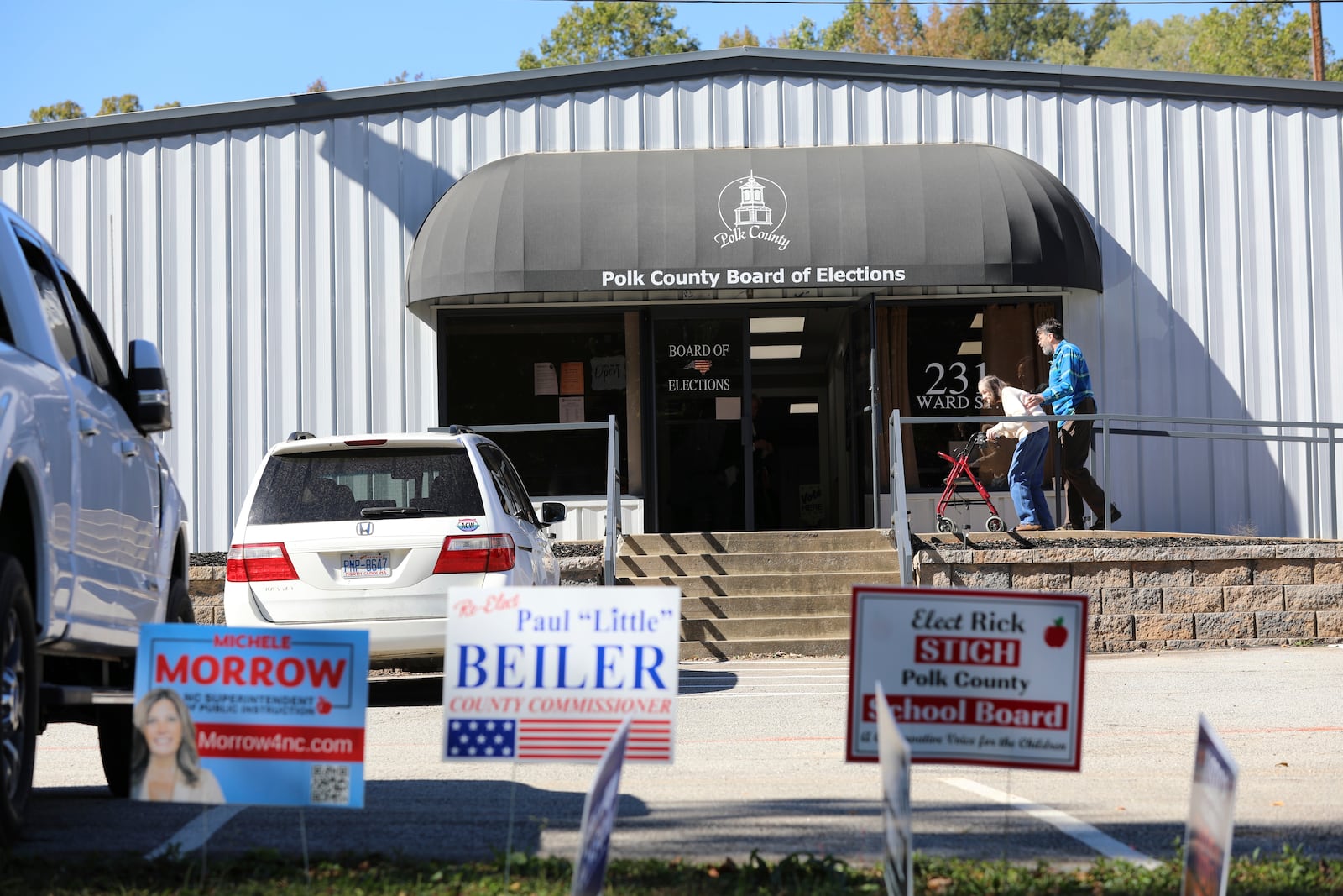 People head inside the Polk County, North Carolina, Board of Elections on the first day of early voting in the state on Thursday, Oct. 17, 2024, in Columbus, N.C. (AP Photo/Jeffrey Collins)