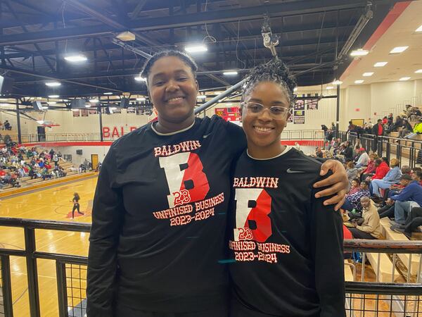 Baldwin High's Kassidy Neal (left) and Madison Ruff  after their first-round playoff win over Southeast Bulloch High Wednesday. Tasha Butts’ jersey number (23) is inset in the logo of their shirts.