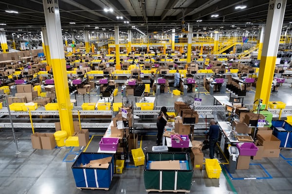 People box items at Amazon’s robotic fulfillment center in Stone Mountain on Wednesday, Oct. 23, 2024. (Ben Gray for the AJC)