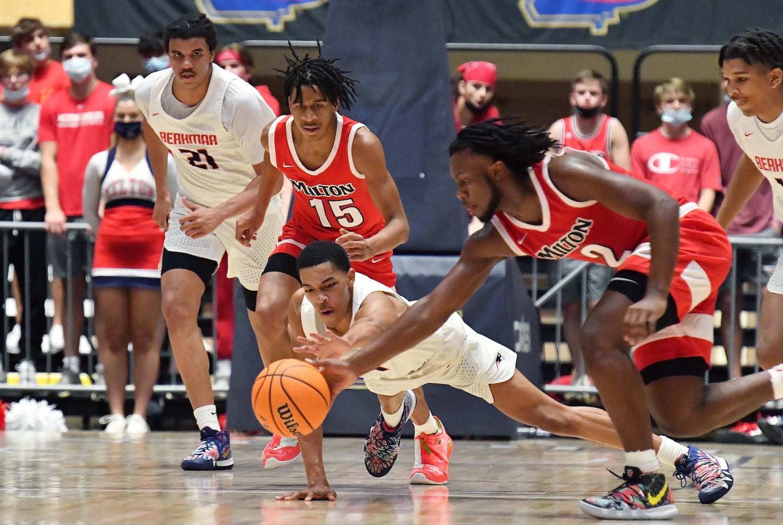 Milton's Bruce Thornton (2) challenges Berkmar's Destin Logan (4) on a loose ball during the Class 7A boys championship game Saturday, March 13, 2021, at the Macon Centreplex in Macon. Milton won 52-47. (Hyosub Shin / Hyosub.Shin@ajc.com)